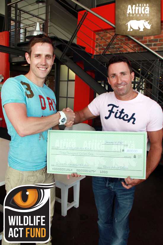 Wildlife ACT receives a cheque from Rhino Africa MD David Ryan Wildlife ACT receives a cheque from Rhino Africa MD David Ryan
