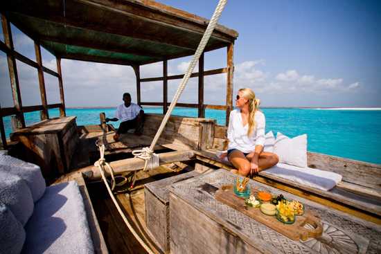 Catching a ride on a traditional dhow at Mnemba Island Lodge