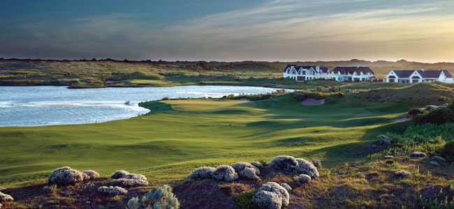 St Francis Links golf court, with a lake and small cottages on the background