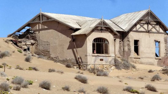 Sand Dunes & Wind Claiming This House | "Nearby Kolmanskop has been a ghost town since 1954. There have been a number of award winning photos taken of the houses along with many movies being made such as: “The King is Alive” in 2000, “Dust Devil” in 1993, a series in 2010 called “Life after People” along with the filming of other television series."