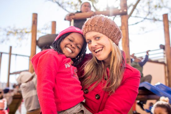 A tourist with a smiling schoolchild