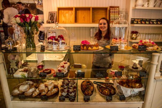 Friendly staff behind cake counter at Four and Twenty in Wynberg