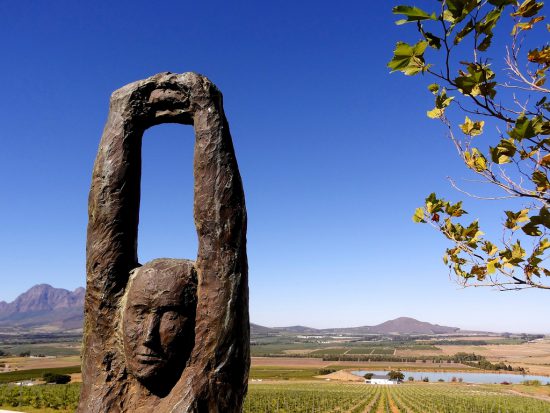 A statue reaches for the sky, outlining the Paarl Wine Route