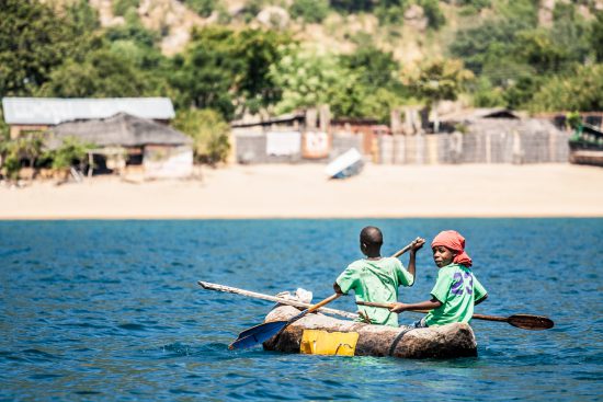 Two boys canoeing in Lake Malawi 