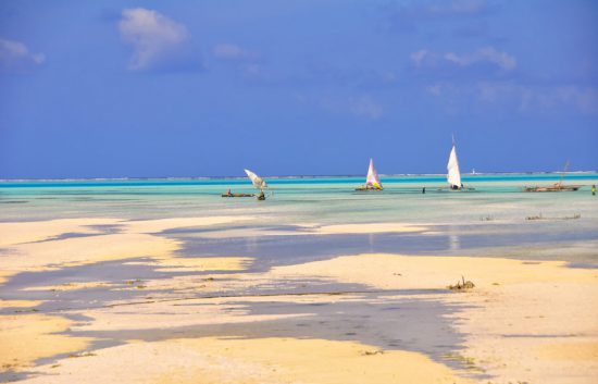 Three dhows at low tide