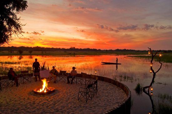 A waterside fire and sunset view