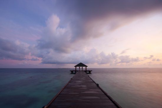 Jetty in the Maldives at sunset Island Holidays