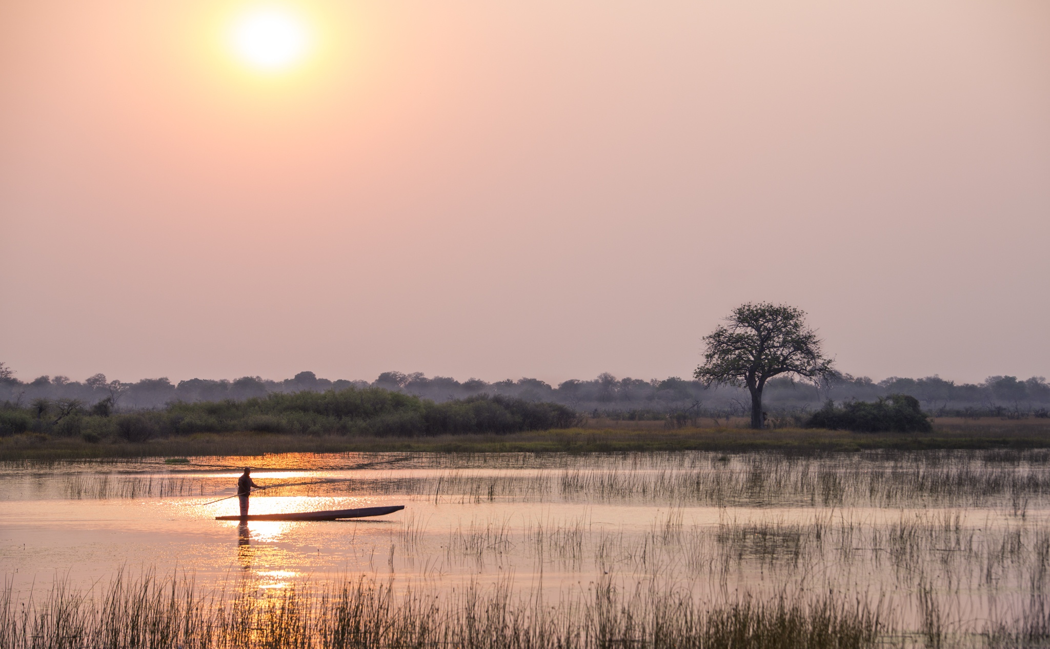 sunset mokoro vumbura plains Okavango Delta in Botswana