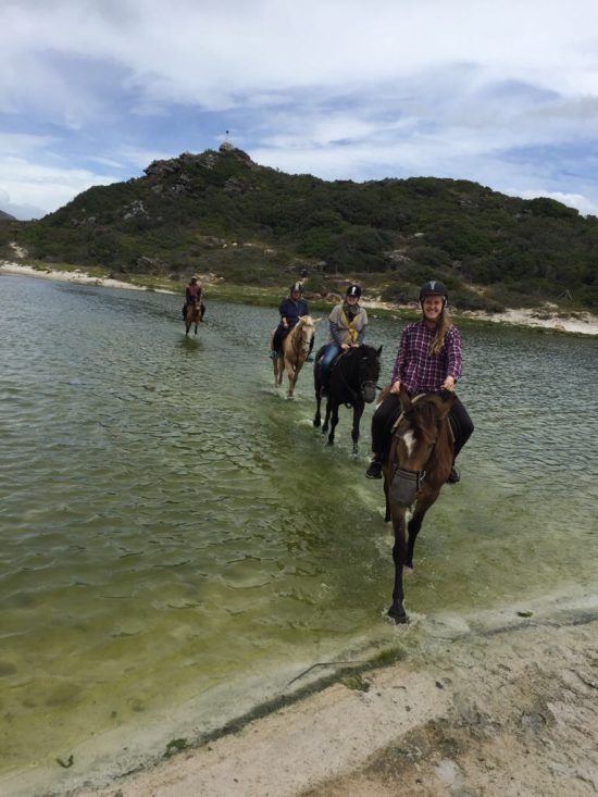 Horse riding across the lagoon to get to Noodhoek Beach