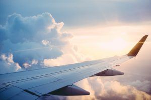 The magic of long haul flying, airplane wing at sunset