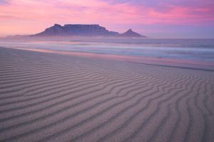 The silhouette of Table Mountain against a pinkish-purple sky