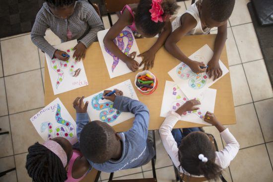 Children colouring in at Khumbulani 