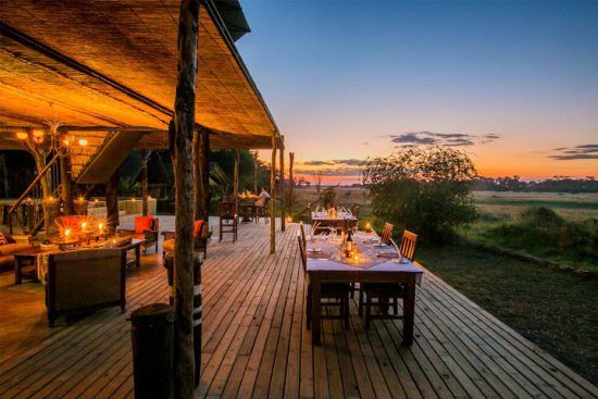 The open-plan dining area at The Hide leads directly into the picturesque savannah