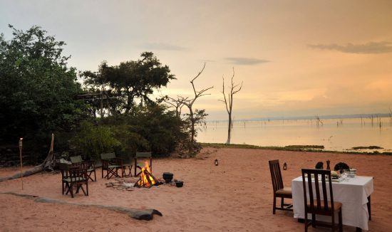 Meals are often served on the sandy shores of Lake Kariba