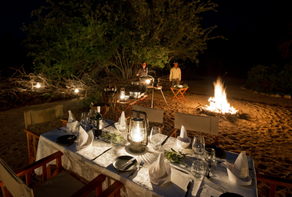 Boma dinner by glowing lamp-light and campfire-cooking