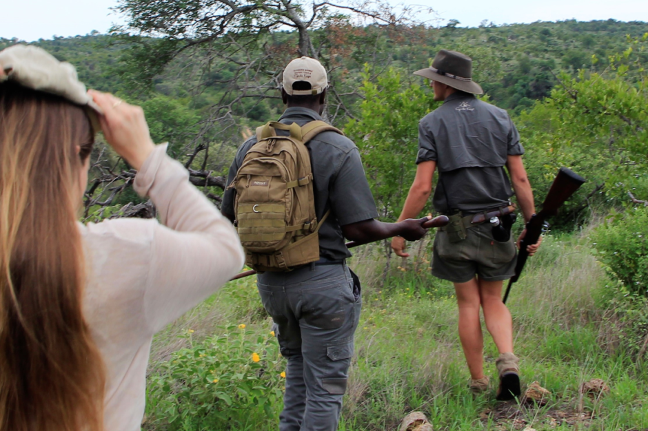 Walking through Big Five wilderness with our Guide, Matt, and Tracker, Casswell