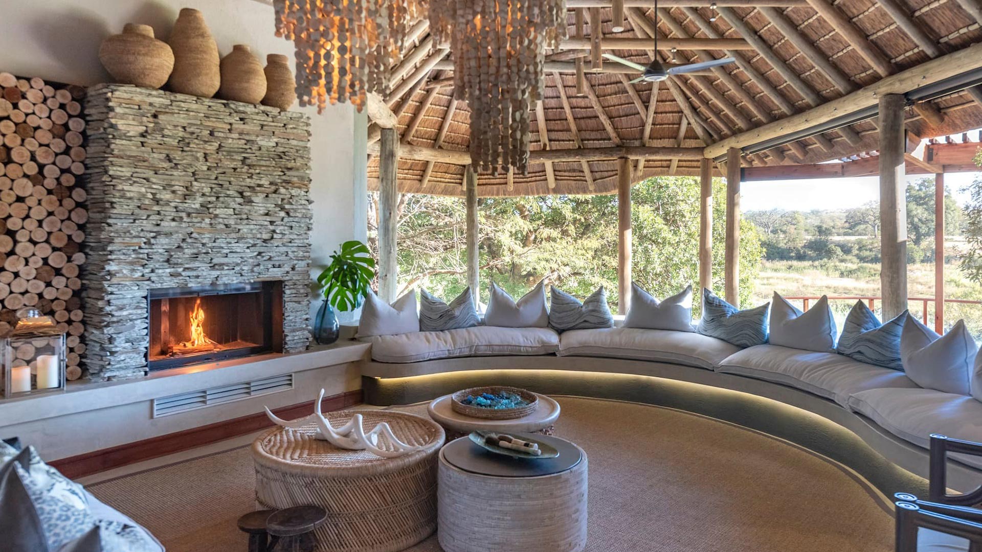 open air lounge with fireplace at Dulini River Lodge