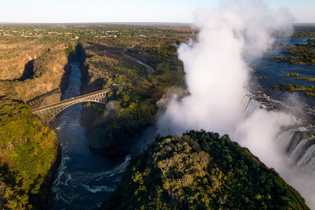 Aerial view from helicopter of Victoria Falls and the bridge