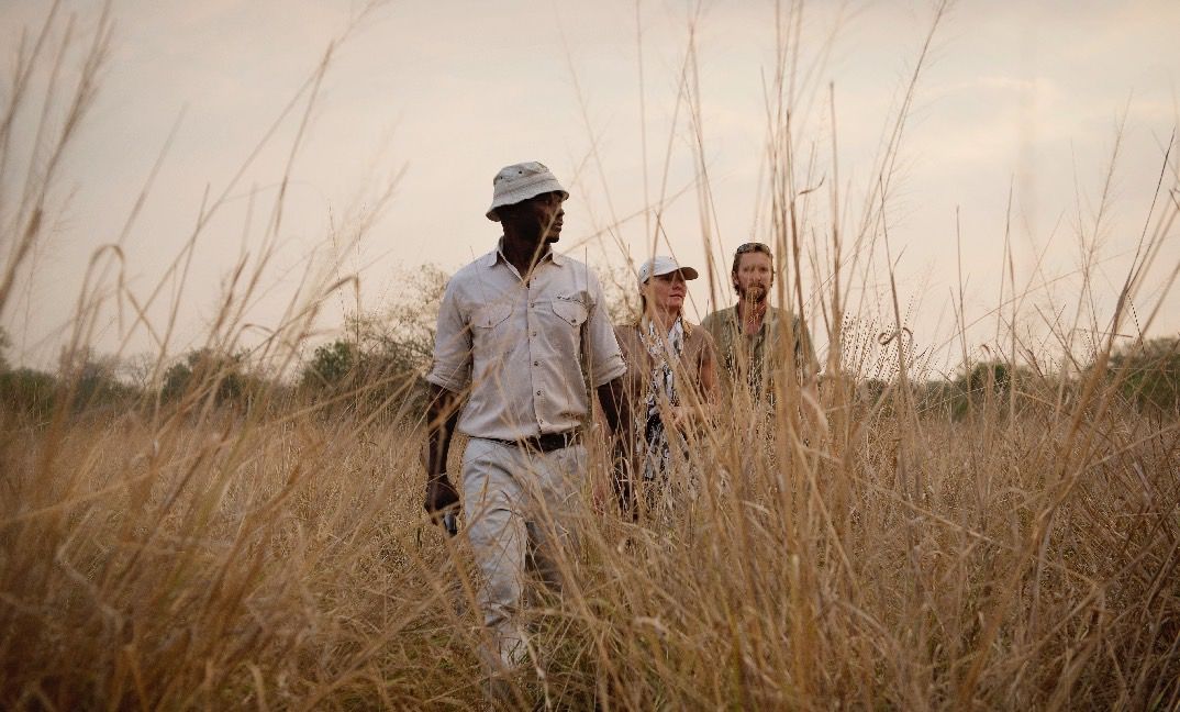 Three people on a walking safari at Sand Rivers Selous in Tanzania 