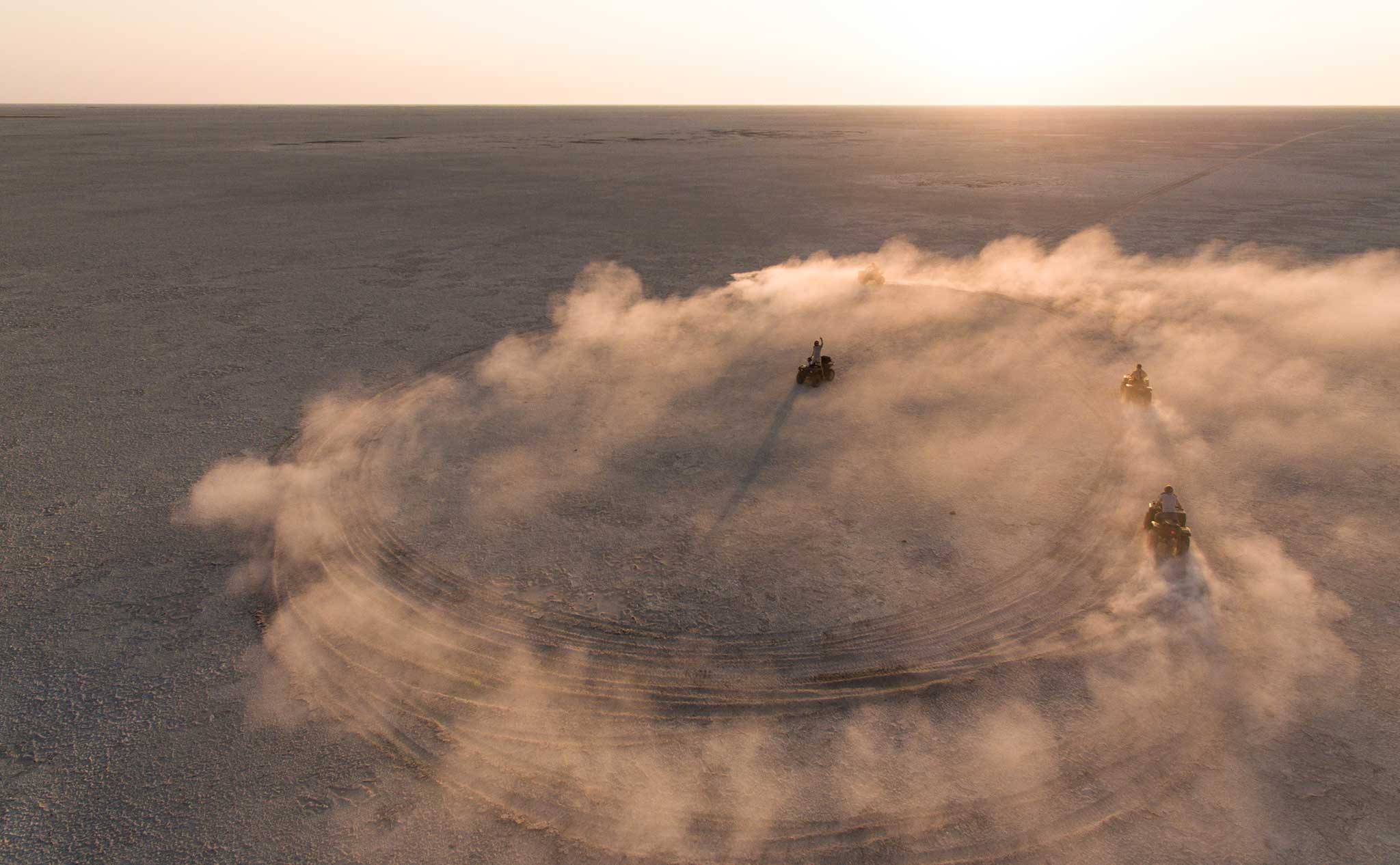 Quad bikes driving across the Makgadikgadi salt pans