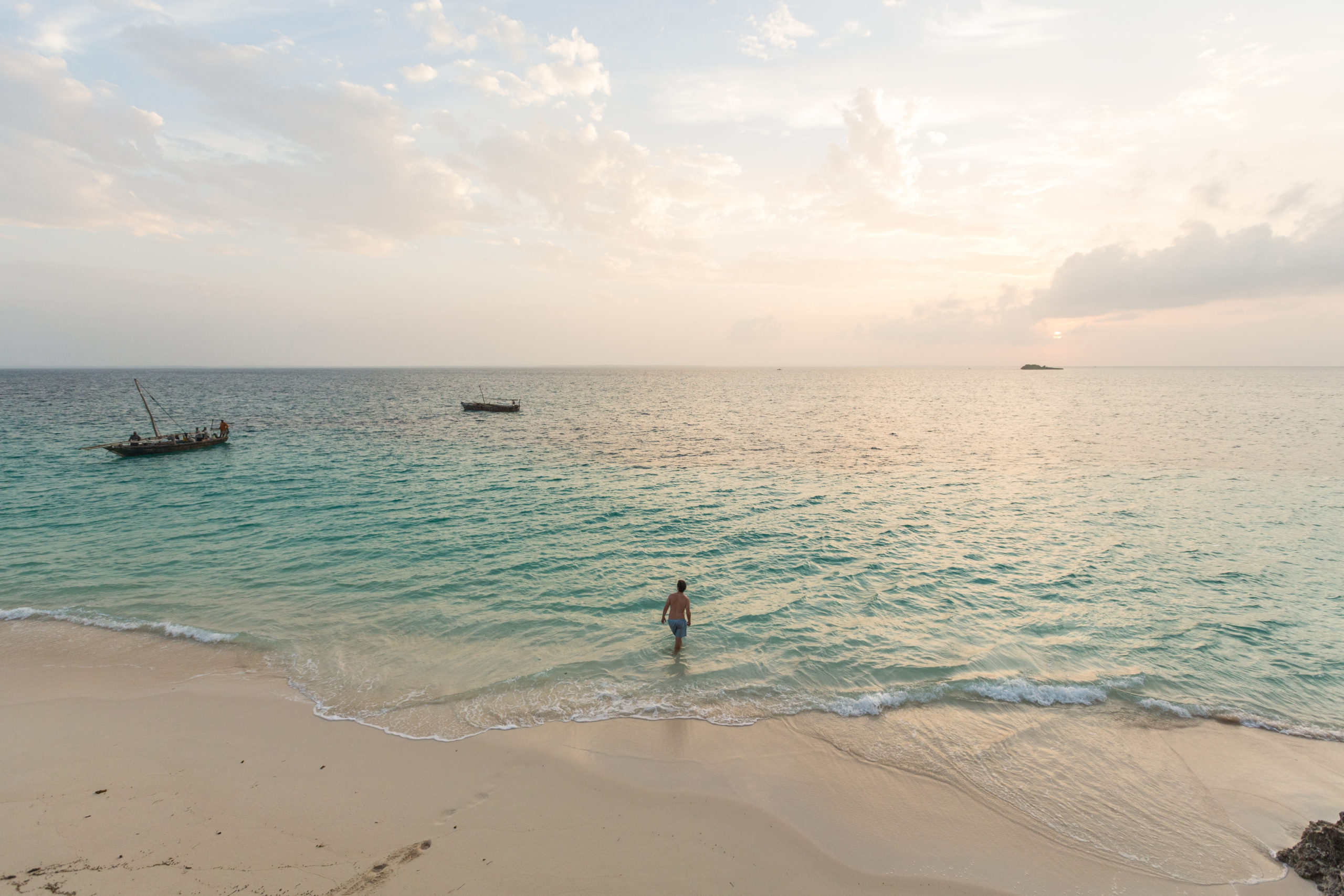 Man walking into ocean alone in Zanzibar