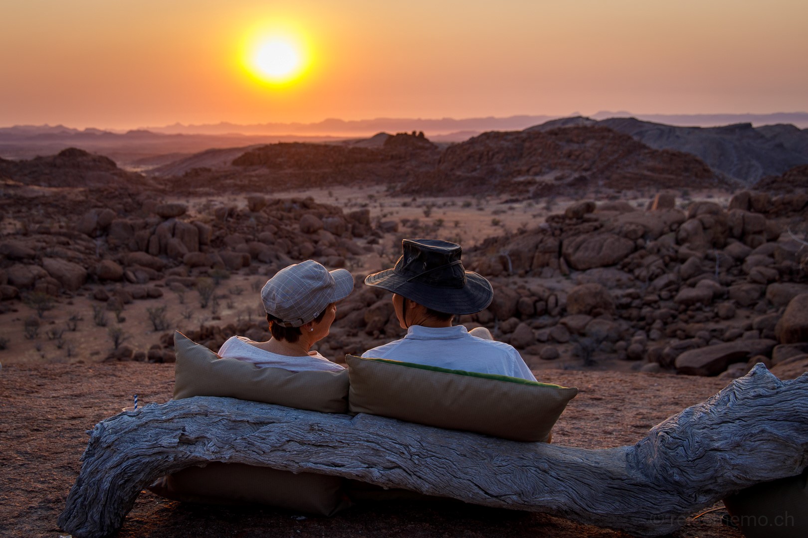 Past guests of Rhino Africa watching the sunset in Namibia