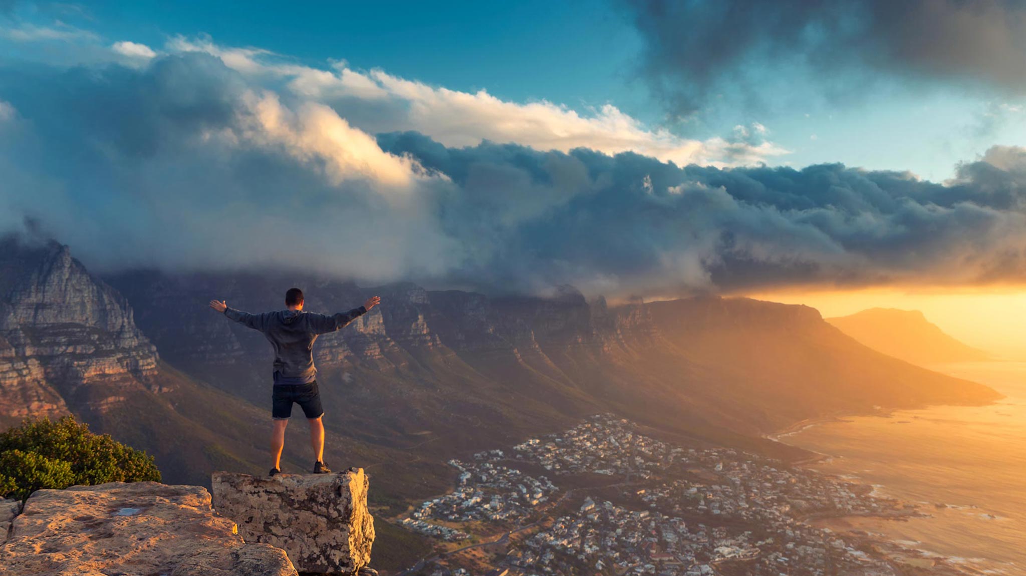 Man standing at the edge of Lion's Head Mountain in Cape Town