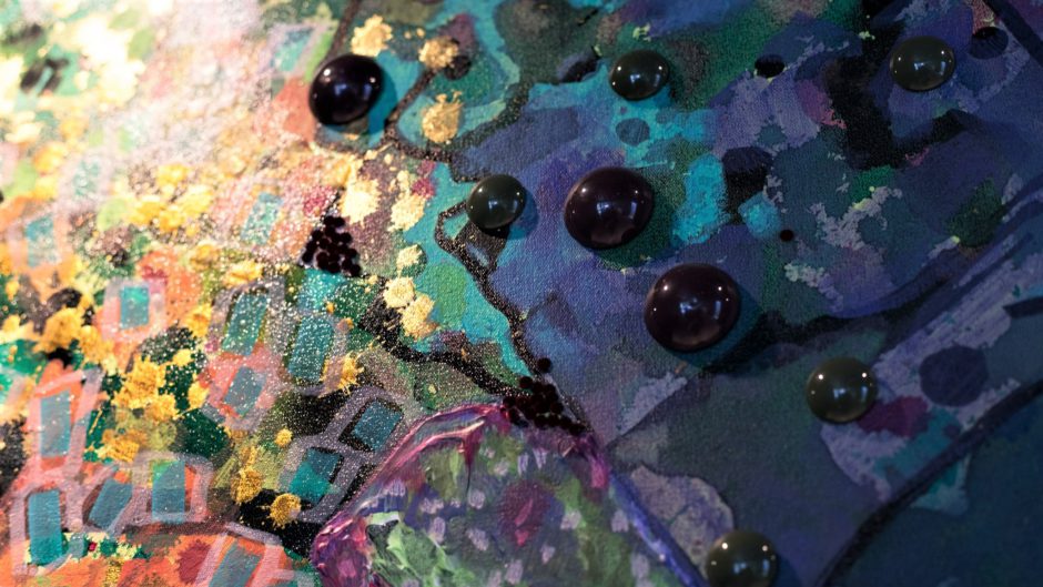 Detailed shot of oil paint, gold leaf and other mixed media