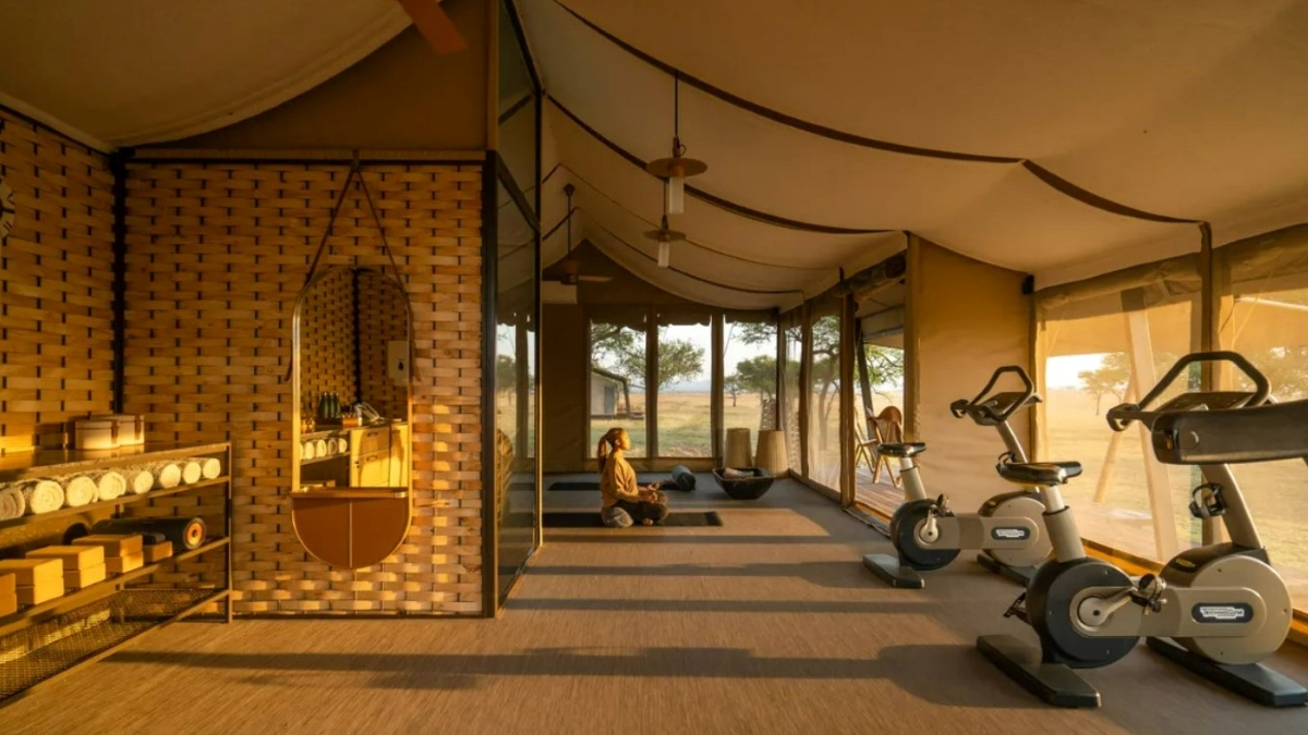 Woman meditating in a spacious tented gym