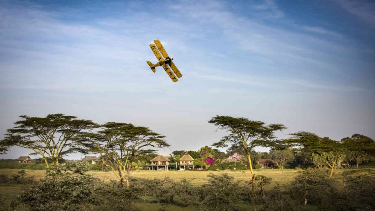 Biplane, similar to the one from the movie 'Out of Africa', flying over Segera retreat