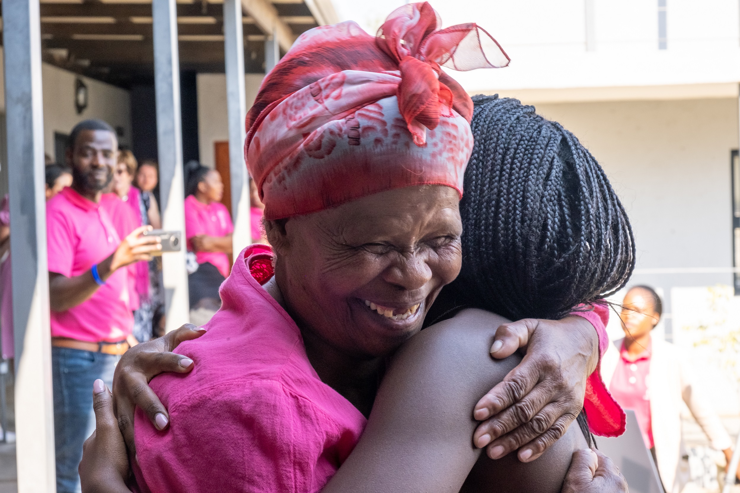 Happy woman hugs child at The Good Work Foundation 10th anniversary 