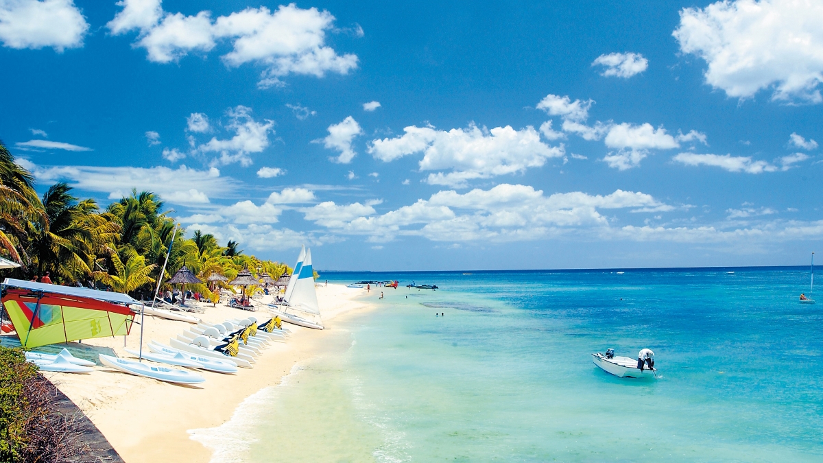 Kayaks lining beach and clear ocean waters 