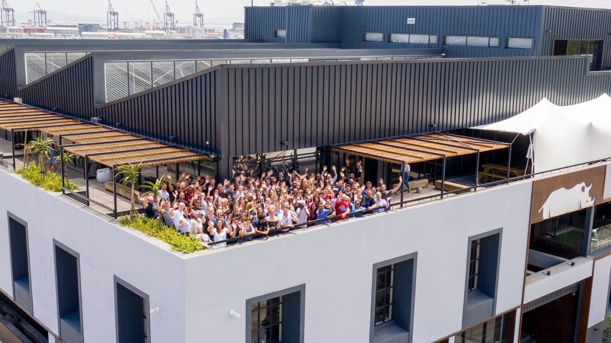 Aerial shot of the Rhino Africa team waving from the roof of HQ