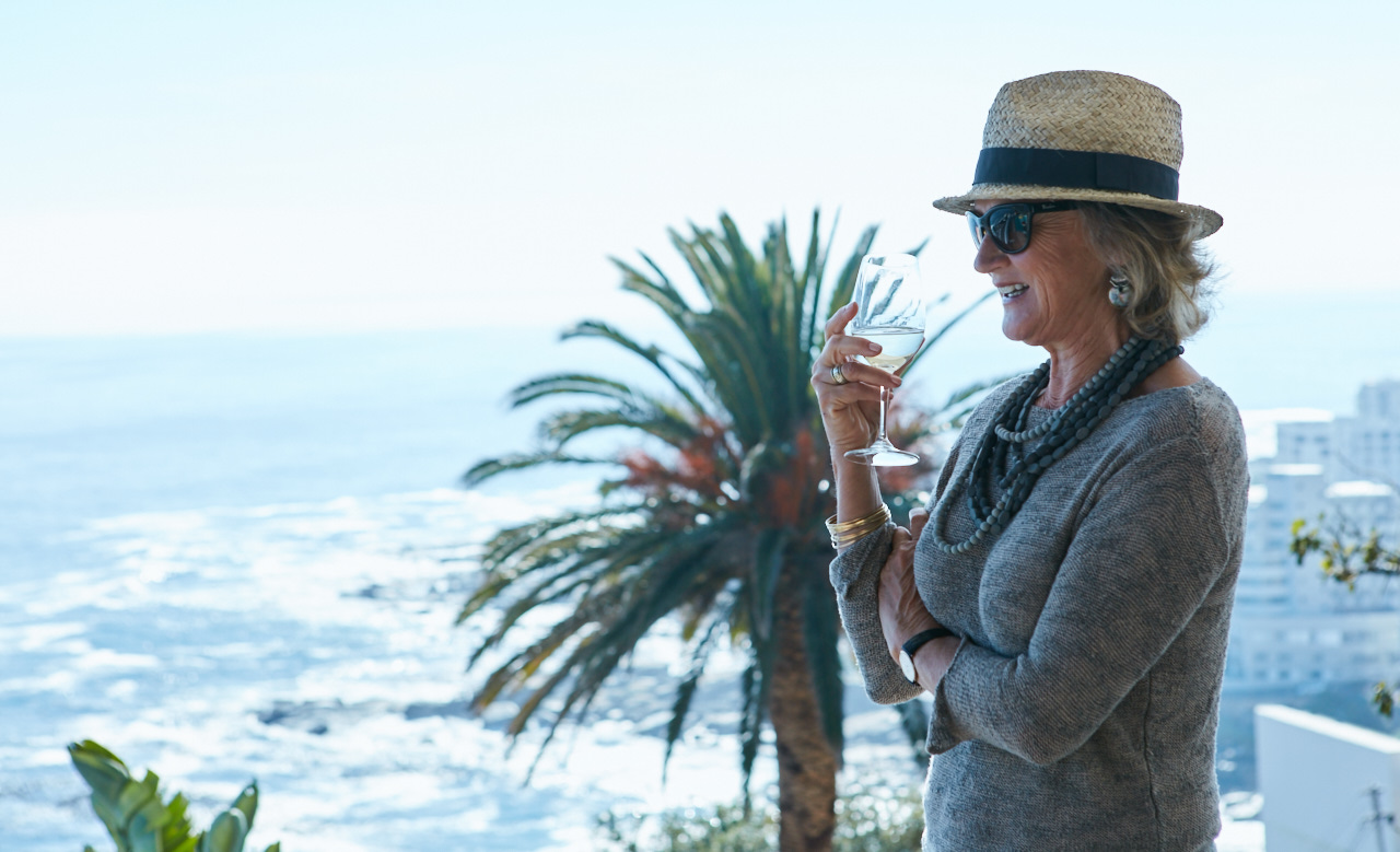 Older woman enjoying wine at Ellerman House