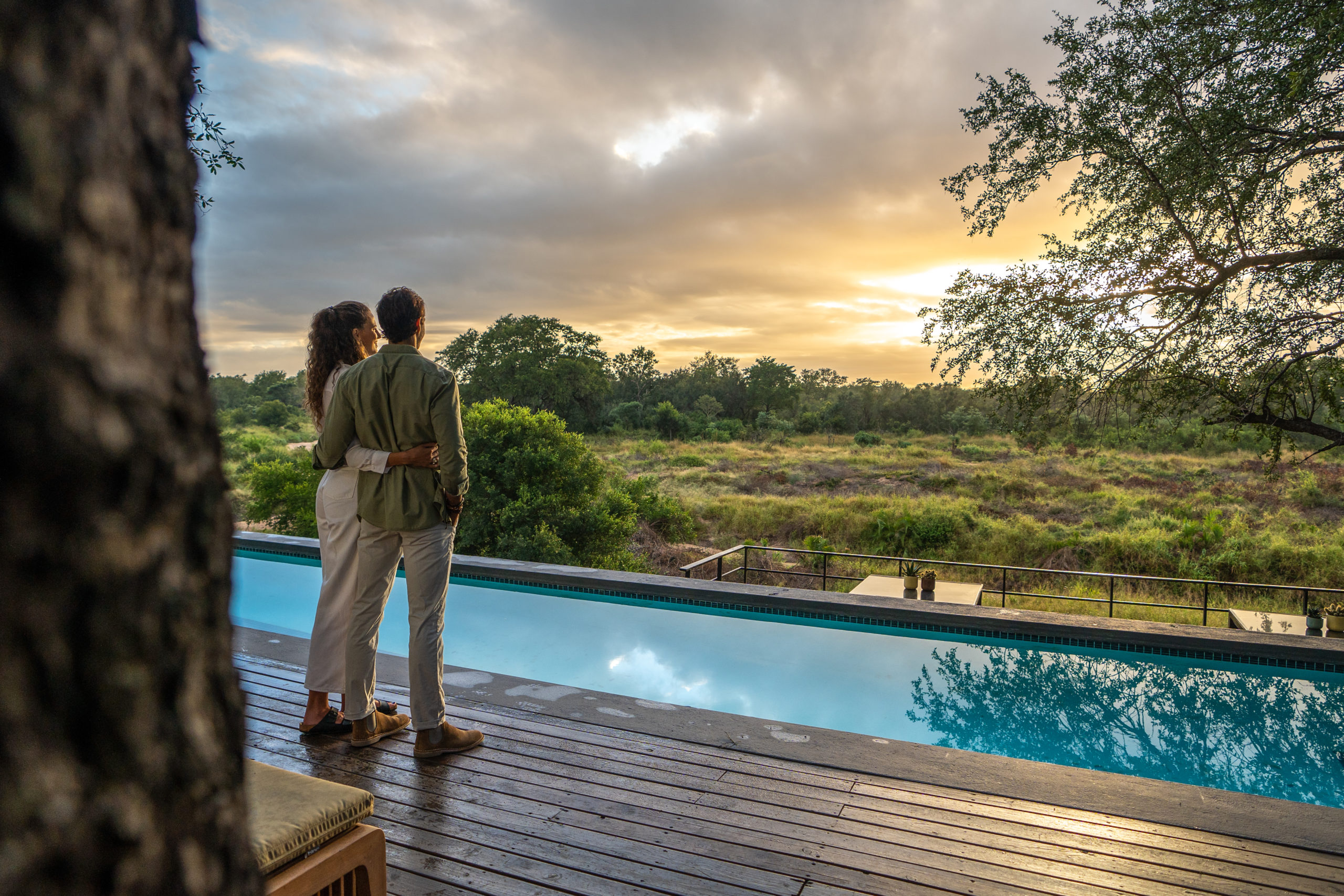 Man and woman looking at view from Silvan's pool