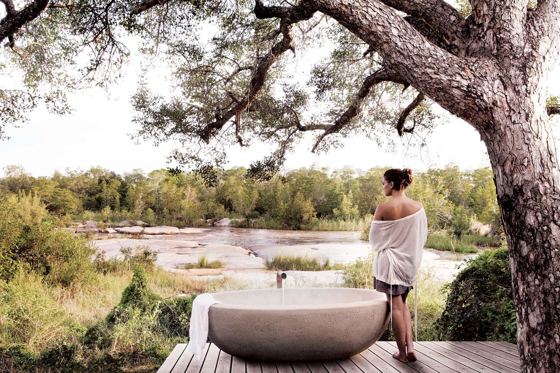 woman standing next to a bathtub outside