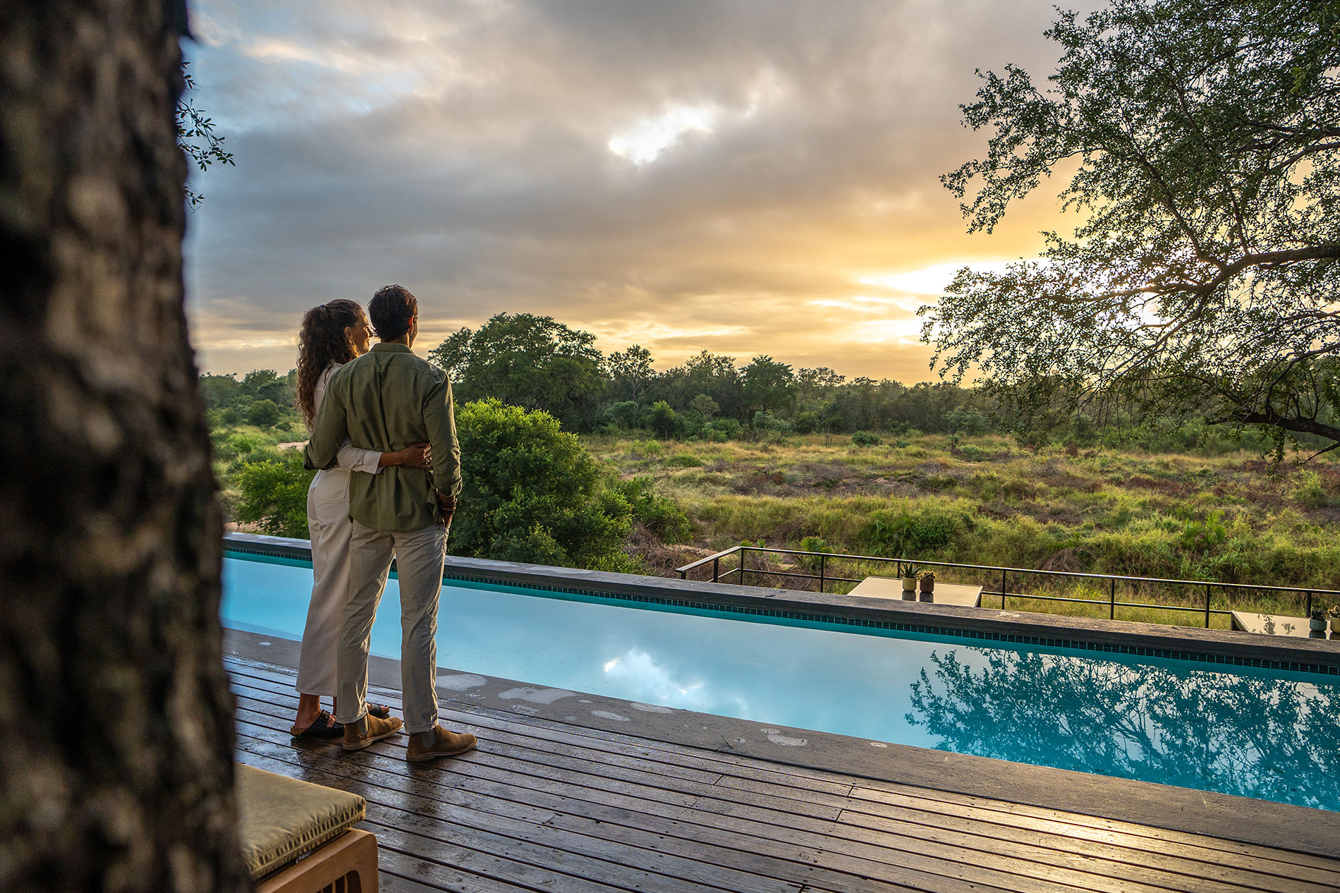 Man and woman looking at view from Silvan's pool