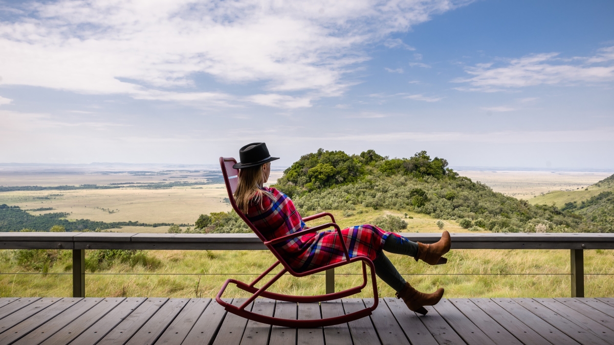 Woman relaxing on a rocking chair on her viewing deck