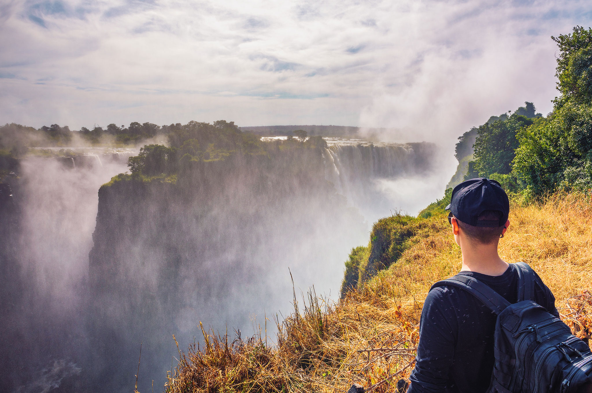 Tourist looks at the Victoria Falls on Zambezi River in Zimbabwe