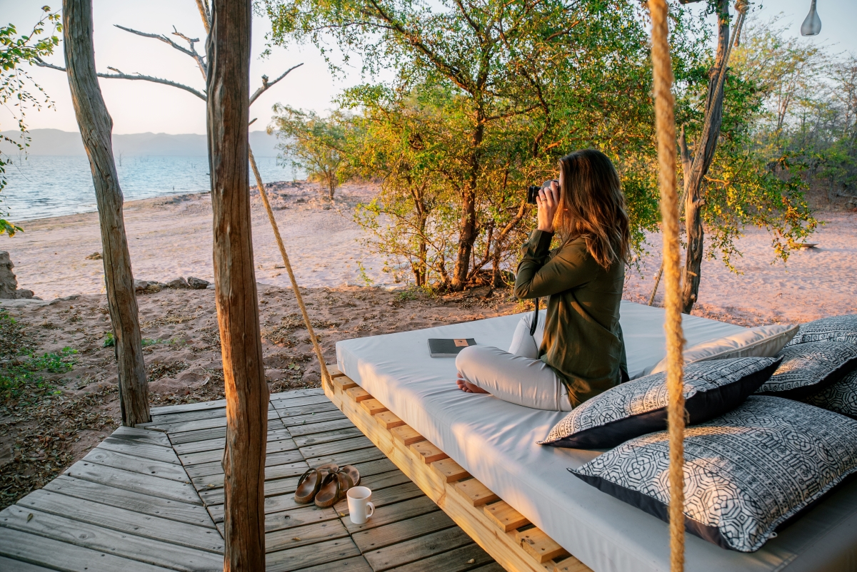 Woman on her private outdoor viewing deck overlooking the lake