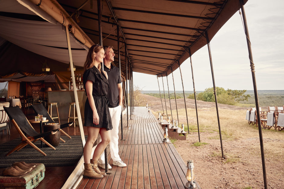 Couple standing in a luxury tent in the Serengeti