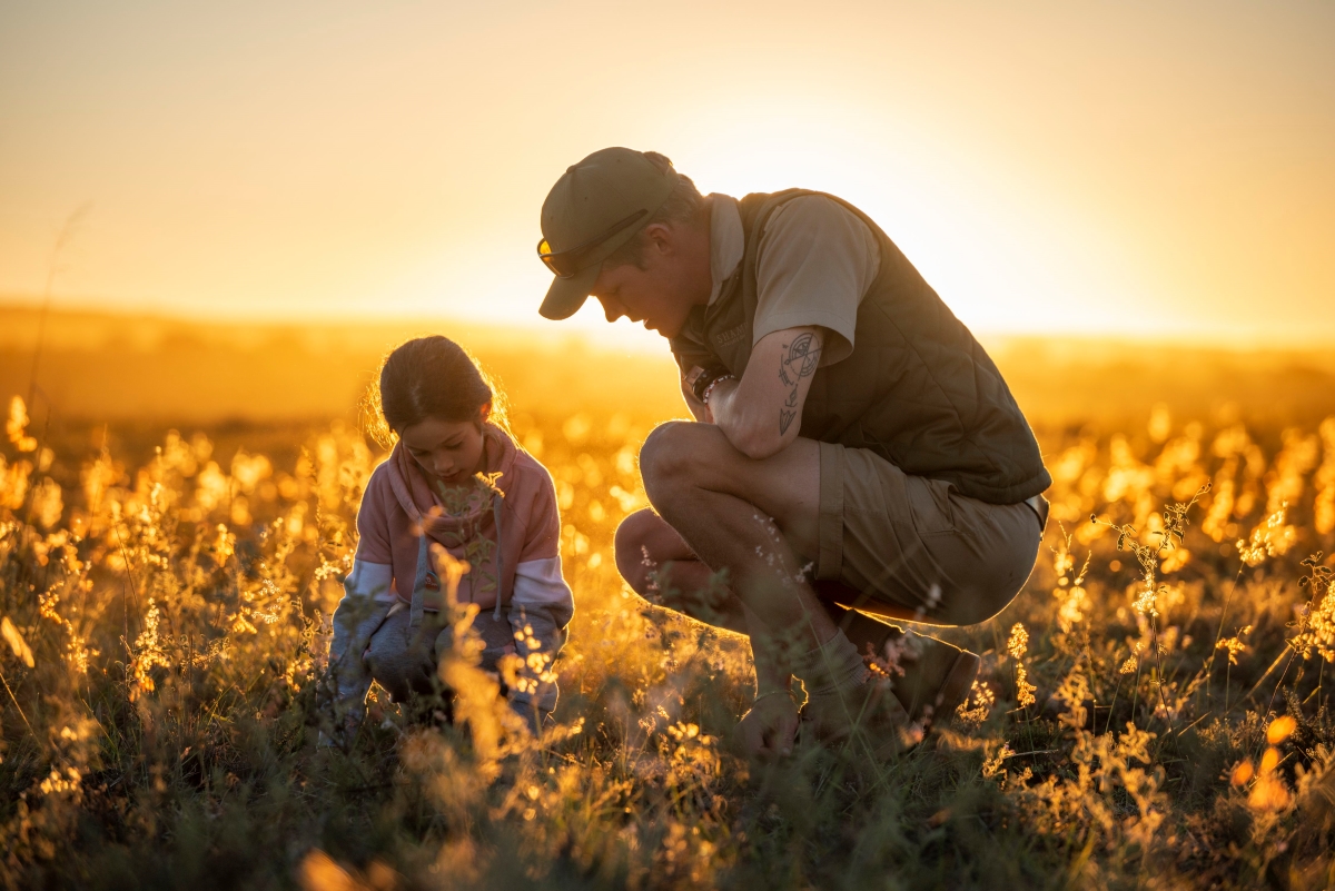 Young girl with ranger learning about nature