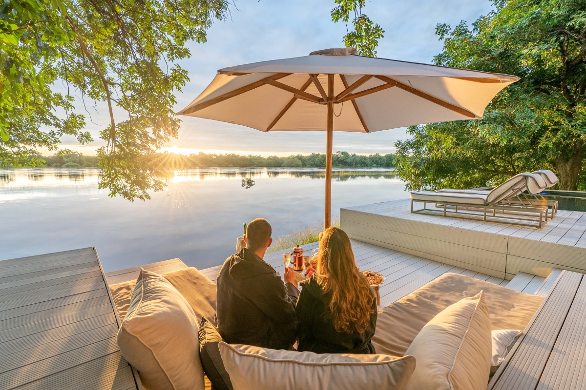 Couple sitting on their private deck overlooking the river