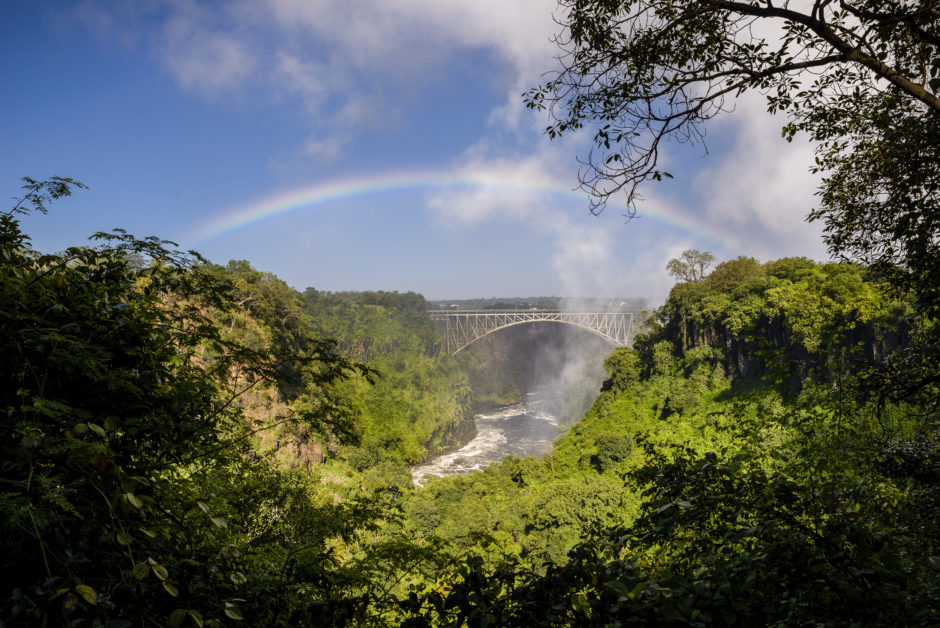 A beautiful rainbow shining over the majestic Victoria Falls