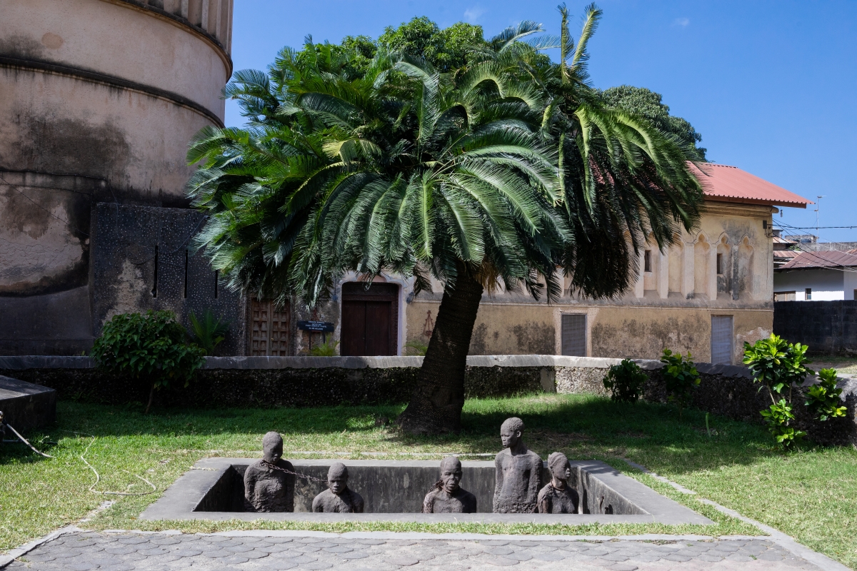 A stone sculpture depicting the chambers where slaves would be held before being auctioned