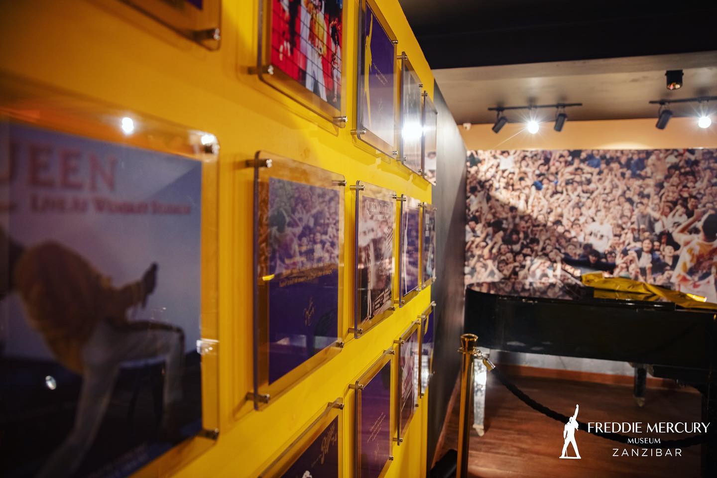 Inside of the museum featuring posters of Queen in their hay-day