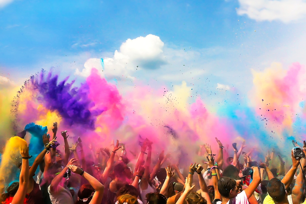 Festivities with people throwing coloured powder 