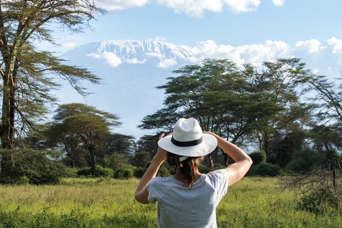 Woman taking a photo of Mount Kilimanjaro