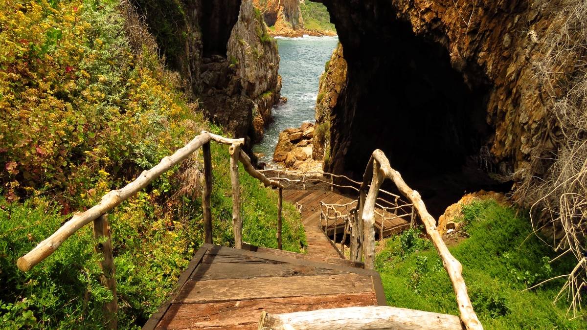 Wooden walkway descending to a lagoon cove