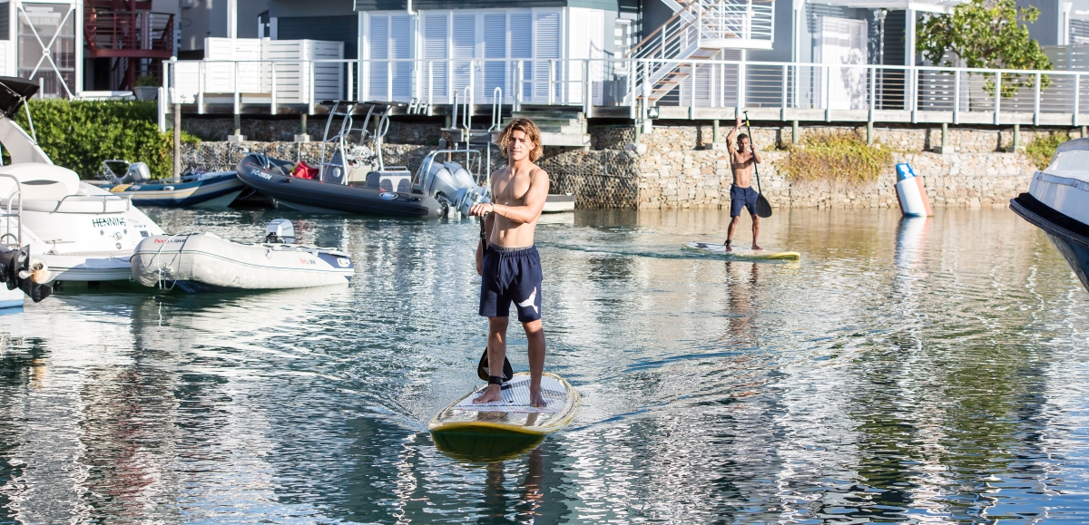 Friends standup paddling in the channels